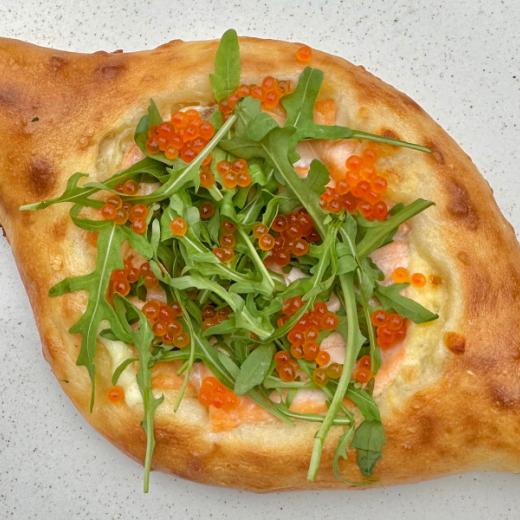 Adjarian khachapuri with salmon and red caviar 